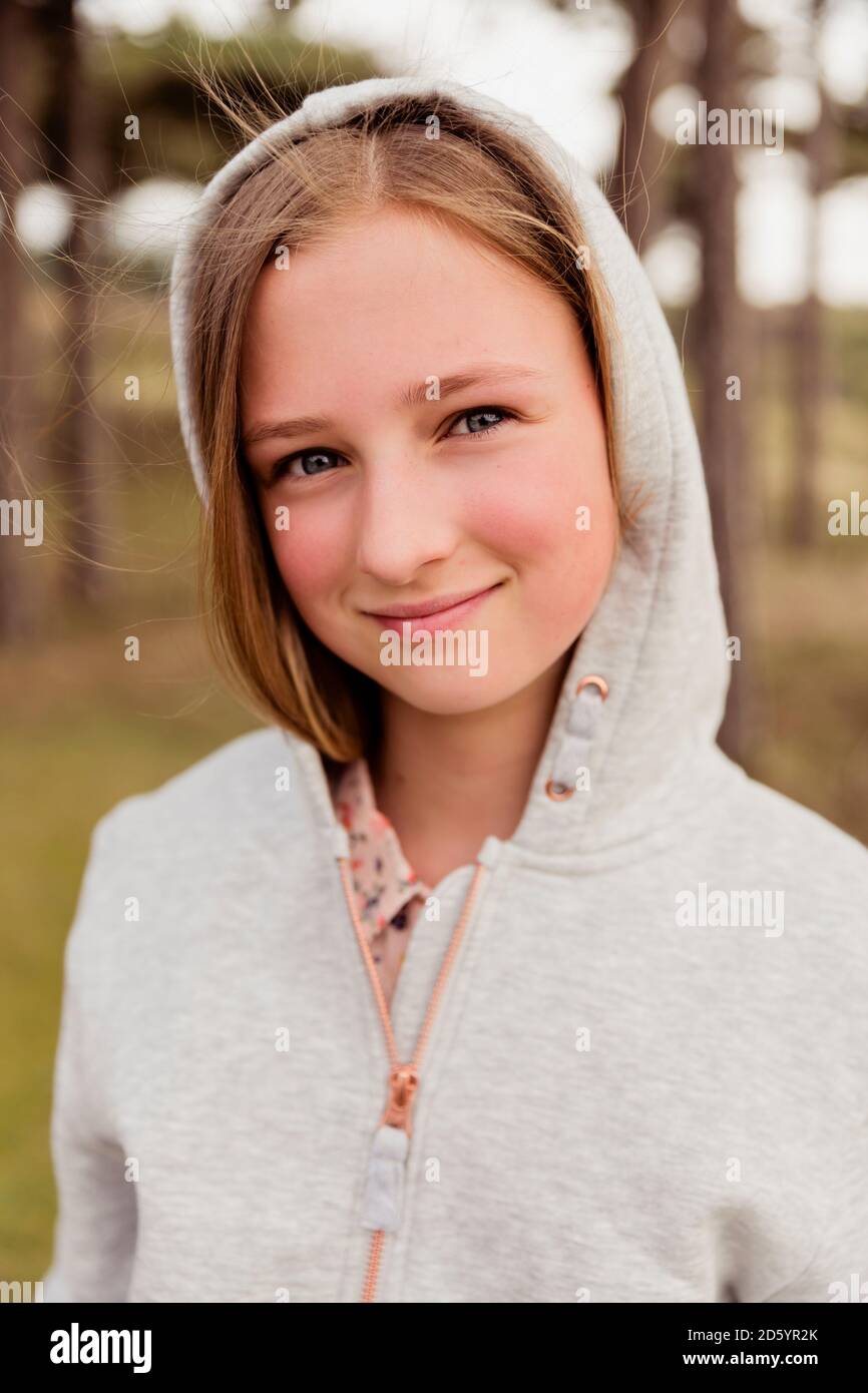 Portrait of smiling girl wearing hoodie Stock Photo