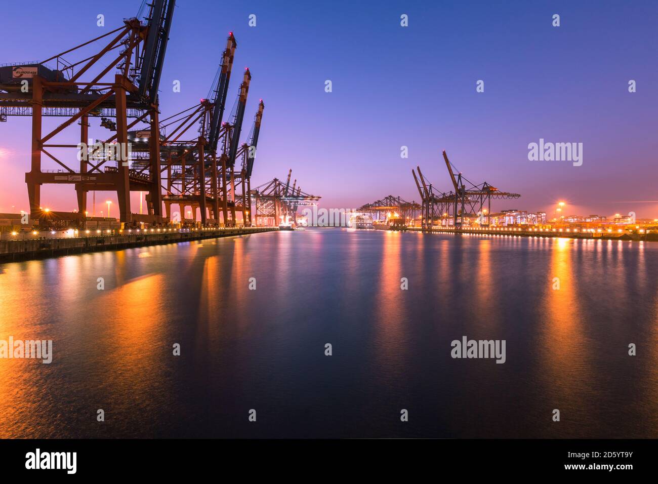 Germany, Hamburg, Port of Hamburg, Container Terminal Burchardkai in the evening Stock Photo