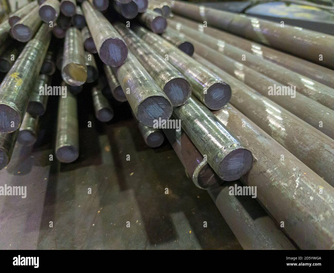 raw stainless steel rods storage - closeup with selective focus and background blur Stock Photo