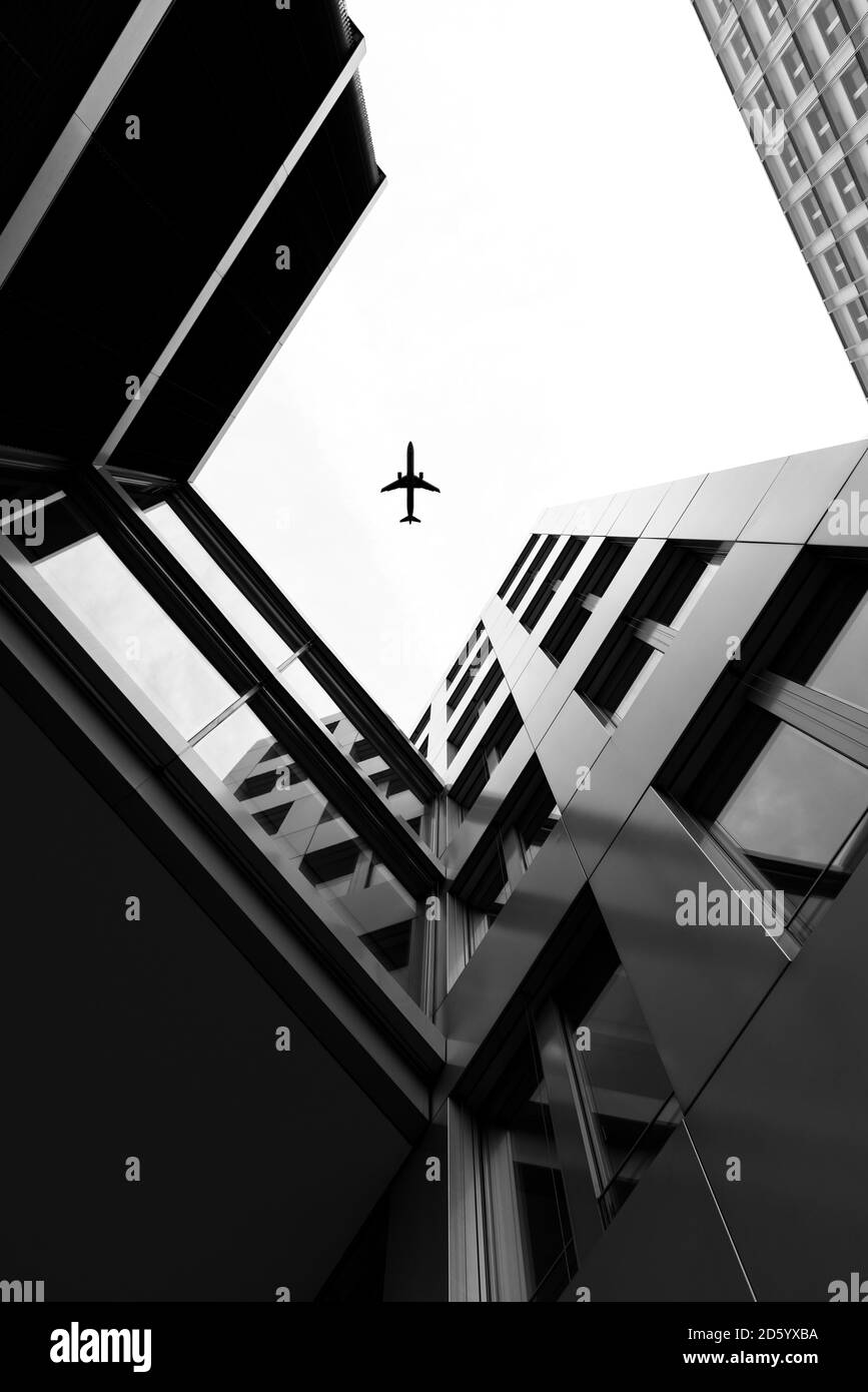 Germany, Duesseldorf, view to plane and facades of high-rise buildings from below Stock Photo
