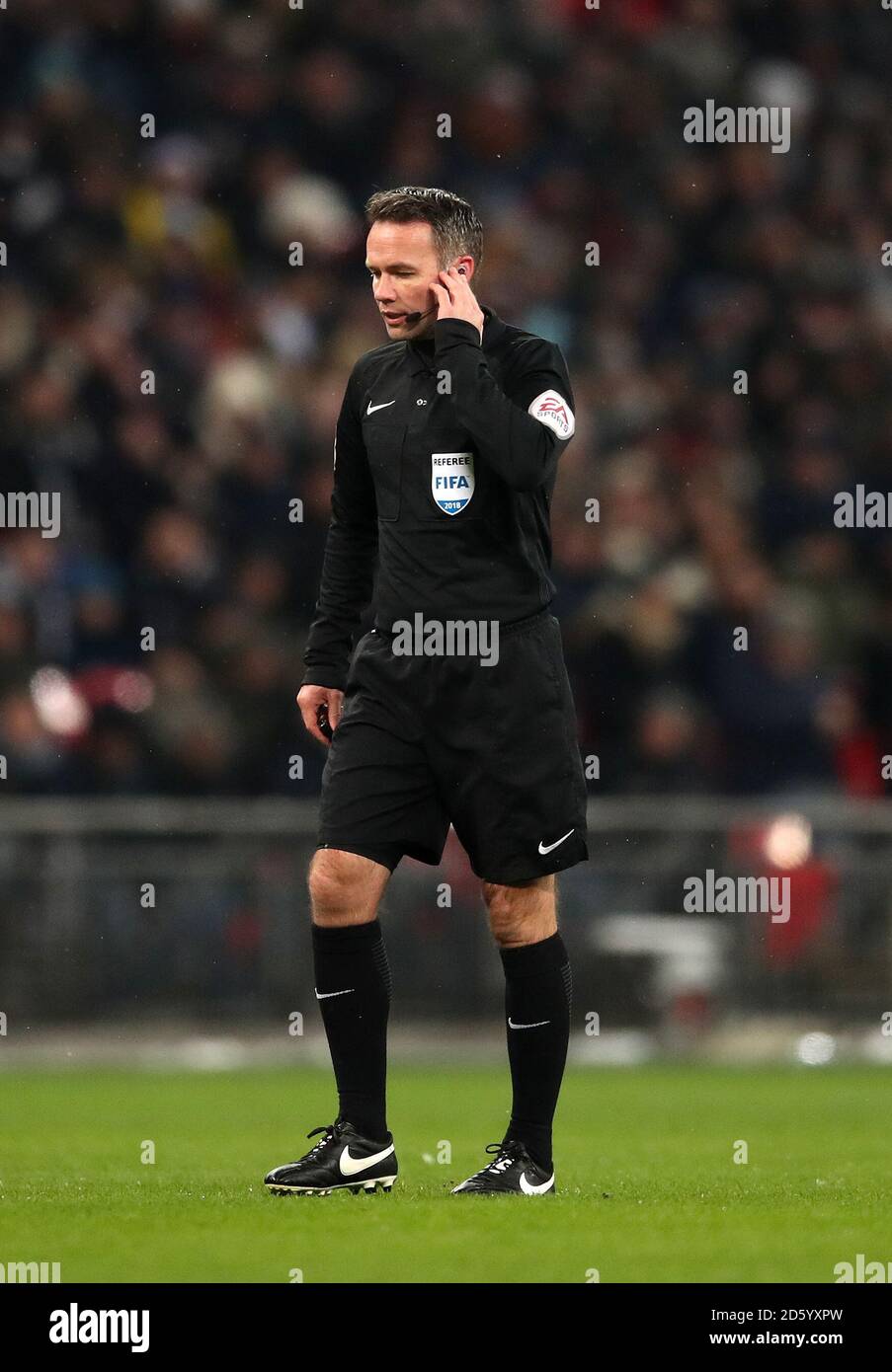 Match referee Paul Tierney uses the Video Assistant Referee system to declare Tottenham Hotspur's Erik Lamela's goal disallowed Stock Photo