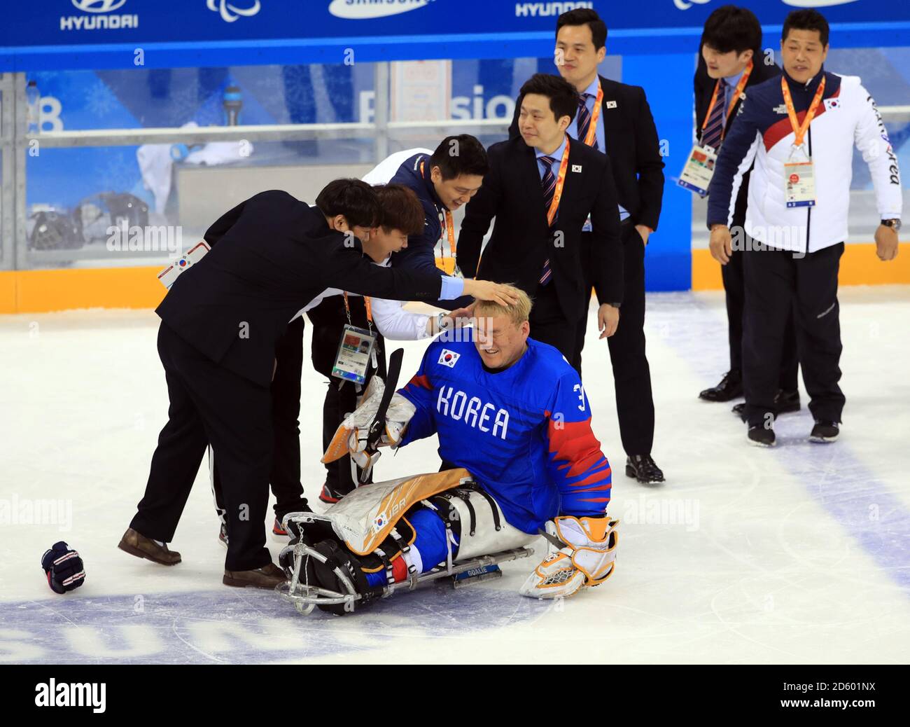 Korea goalkeeper Yu Man Gyrun celebrates their win with the coaches and Manager during day two of the PyeongChang 2018 Winter Paralympics in South Korea Stock Photo