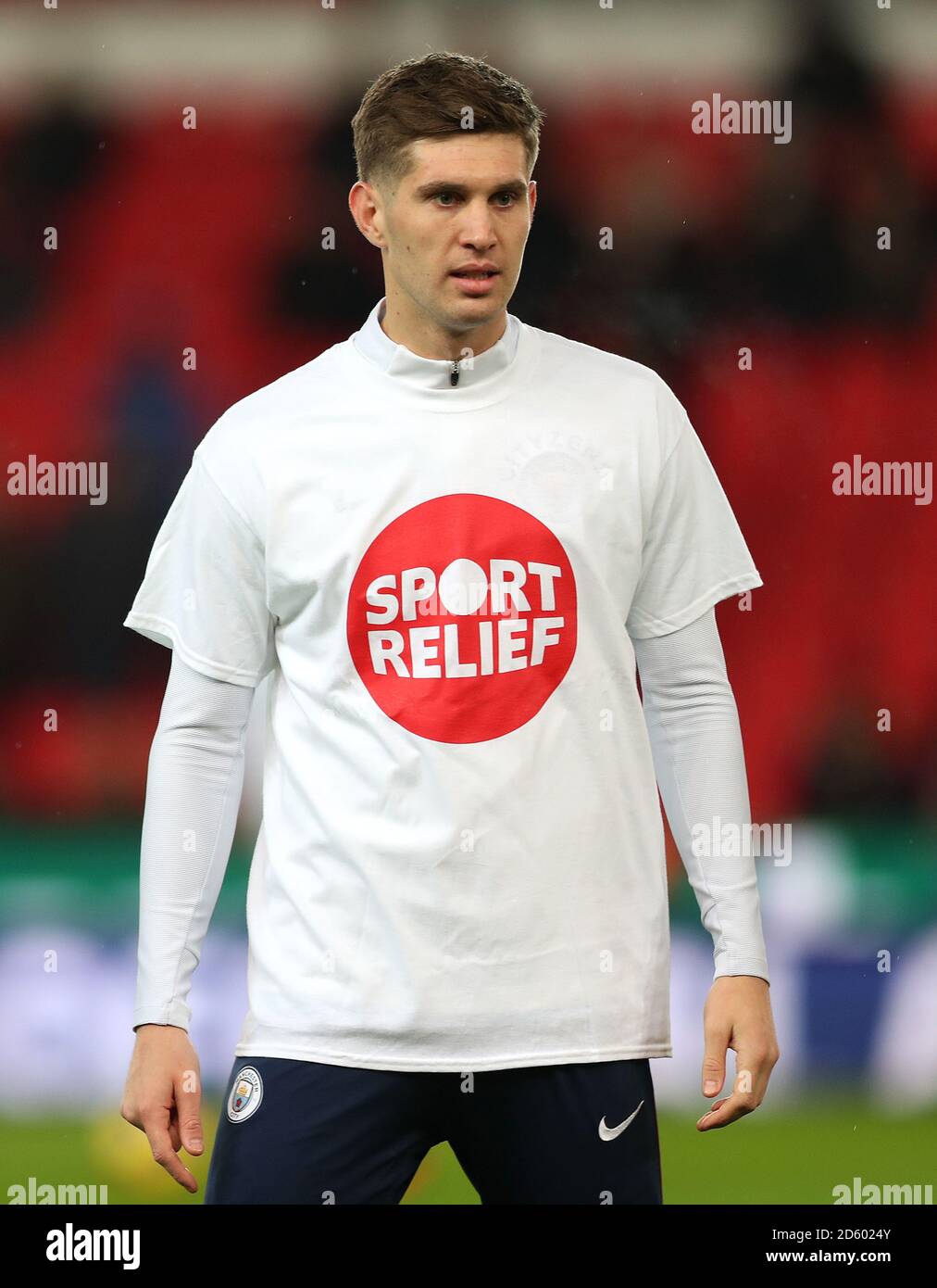 Manchester City's John Stones wearing a Sport Relief t-shirt during the warm-up before the game Stock Photo - Alamy