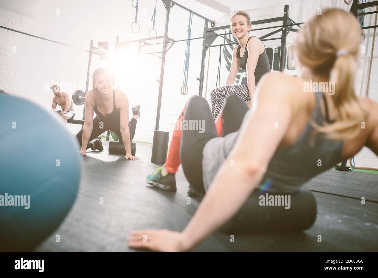 People in gym using foam roller Stock Photo Alamy