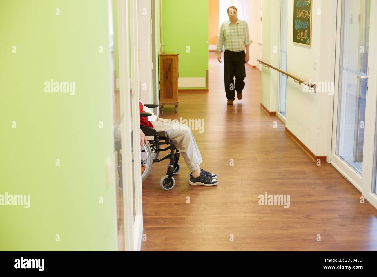 Age demented senior man walking on corridor in a nursing home Stock Photo
