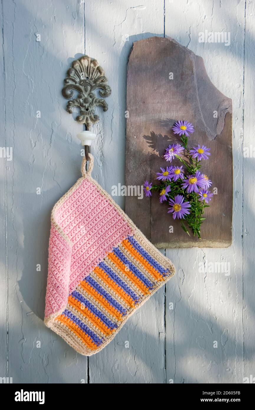 Crocheted potholder hanging at hook Stock Photo