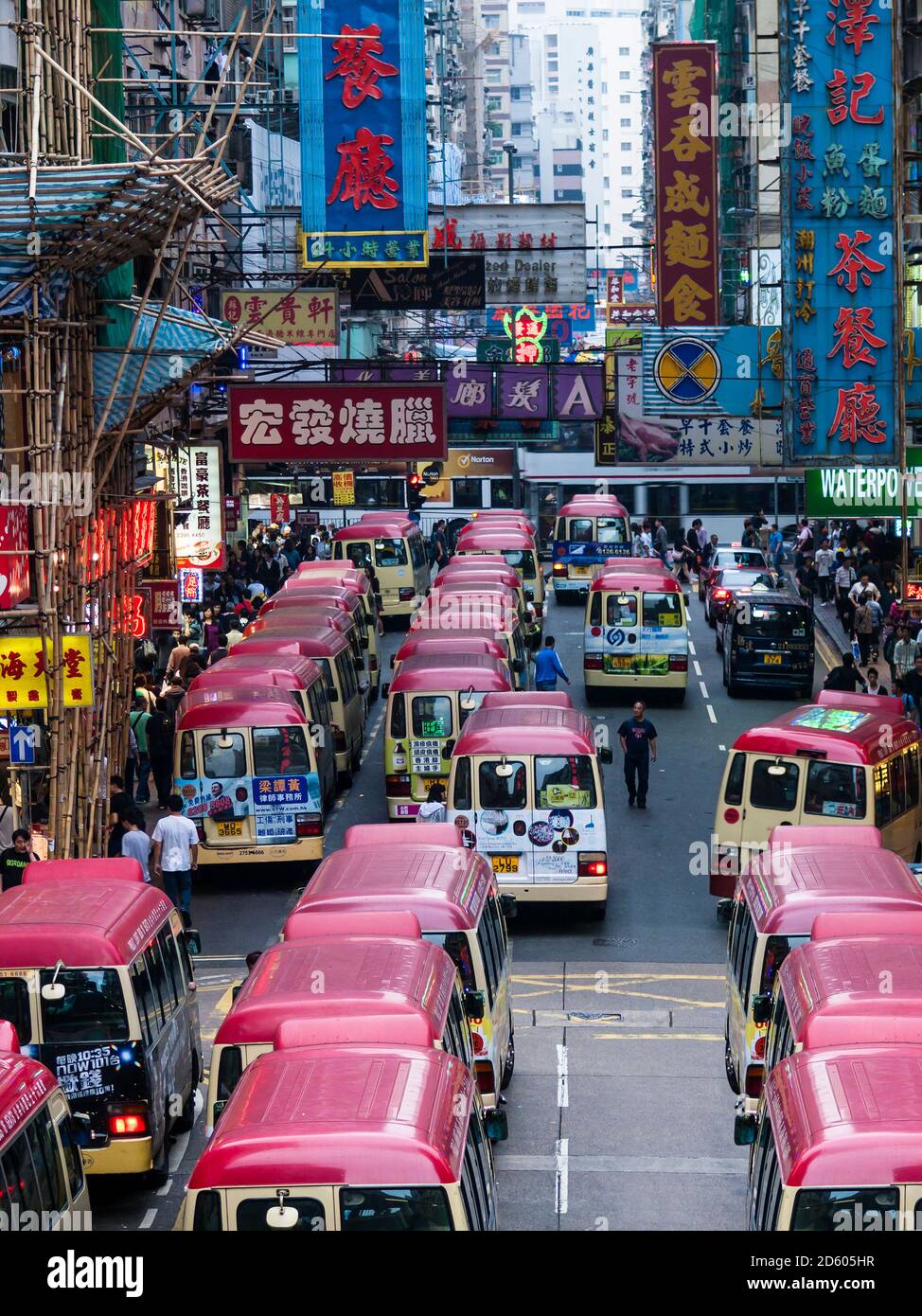China, Hong Kong, Kowloon, street scene with advertising and taxi busses Stock Photo