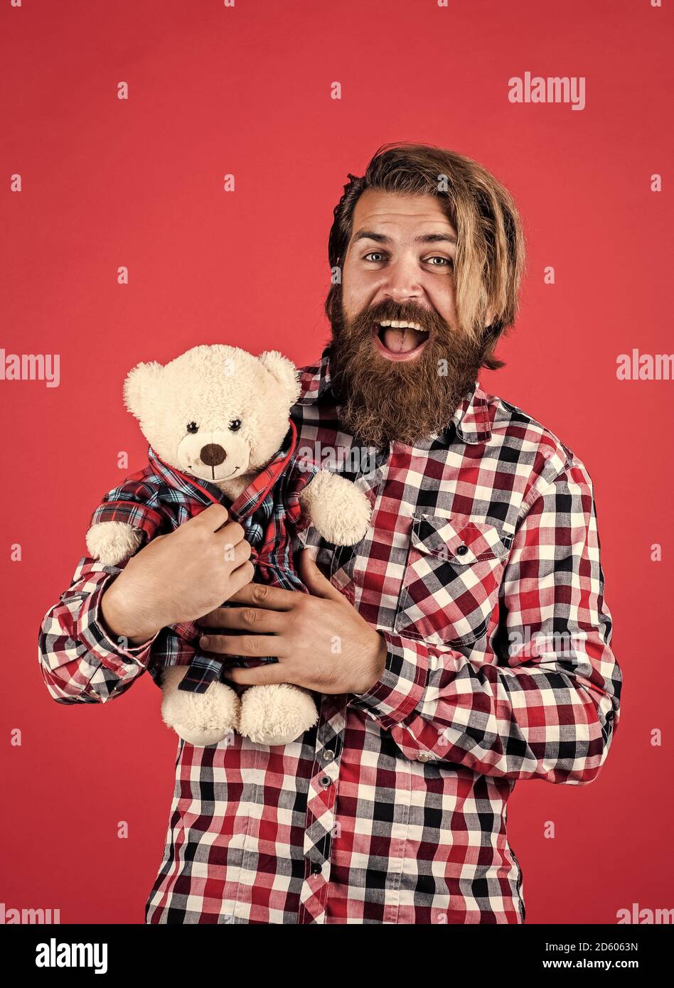 happy valentines day. cheerful bearded man hold teddy bear. male feel playful with bear. brutal mature hipster man play with toy. happy birthday. being in good mood. Stock Photo