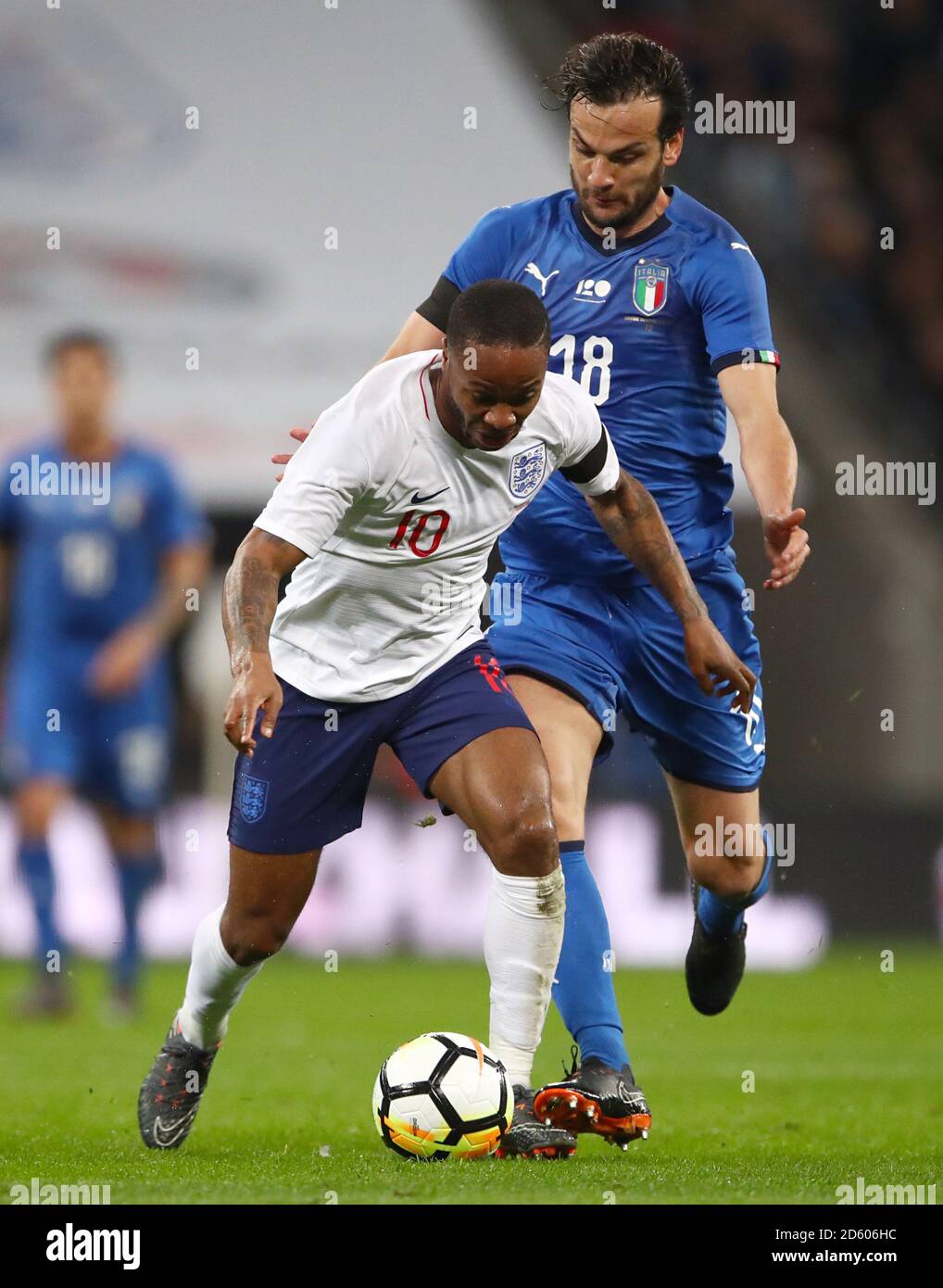 England's Raheem Sterling (left) and Italy's Marco Parolo battle for the ball Stock Photo