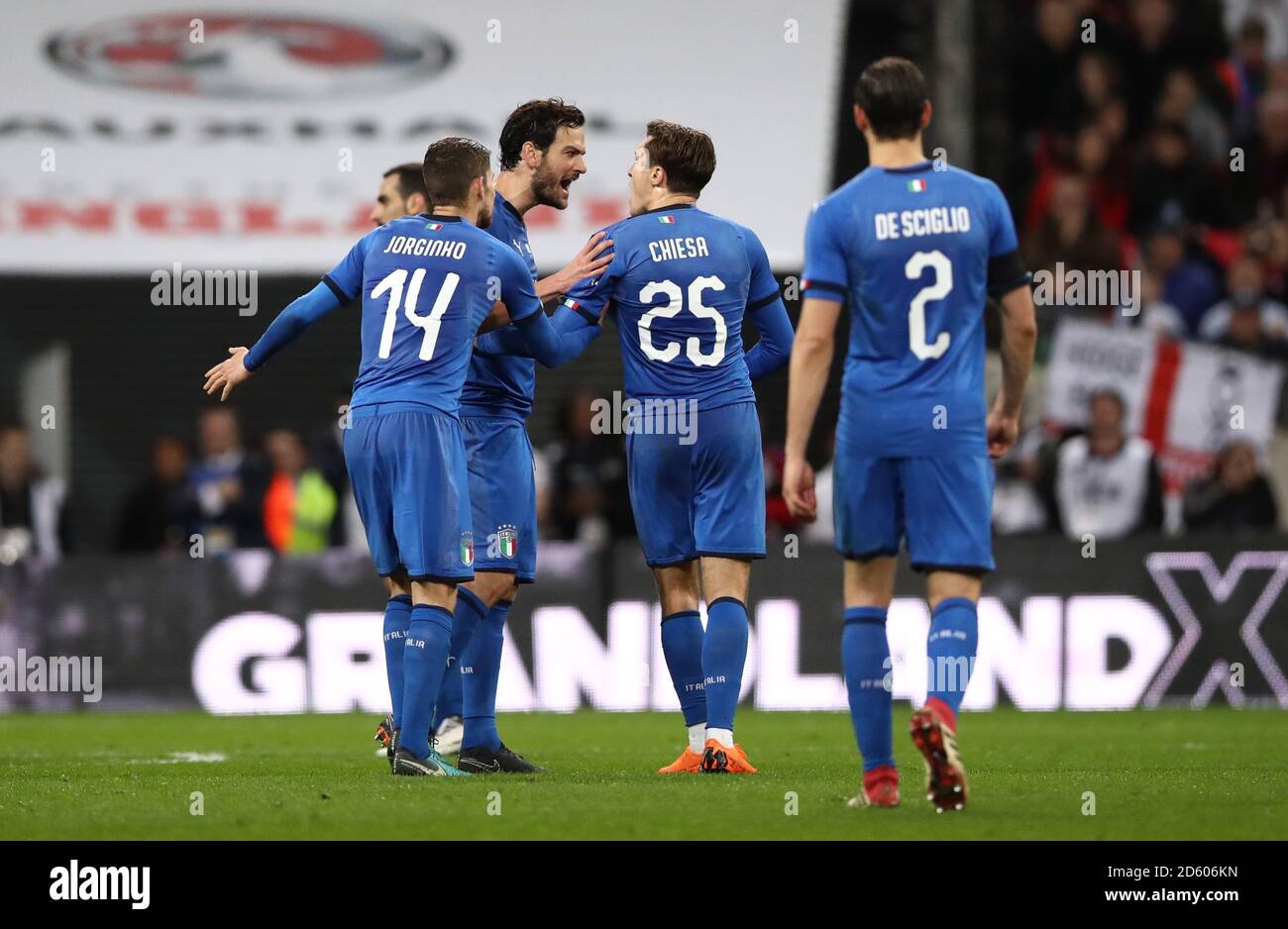Italy's Marco Parolo (centre) exchanges words with Italy's Federico Chiesa as referee Deniz Aytekin (not pictured) reviews the VAR Stock Photo