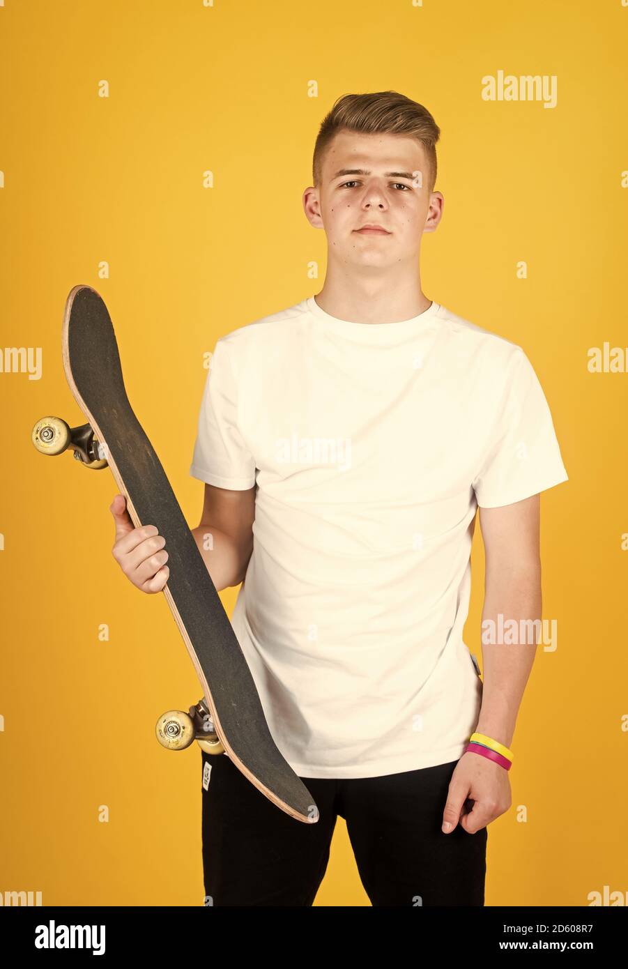teen boy with skateboard. hipster teen boy hold penny board. urban boy with penny  skateboard. young kid has riding hobby. city style. child learns to ride penny  board. trendy teen skater practicing