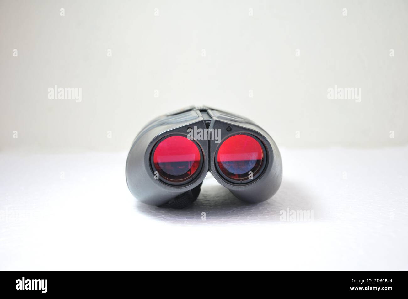 Binocular, Binoculars with red lenses on white background military style with night vision for home use Stock Photo