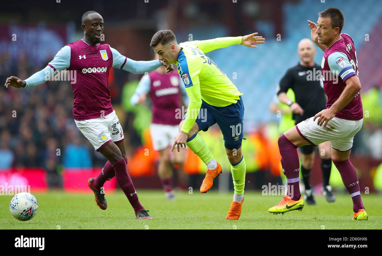 Derby County's Tom Lawrence skips past Aston Villa's Albert Adomah and Aston Villa's John Terry (right)  Stock Photo
