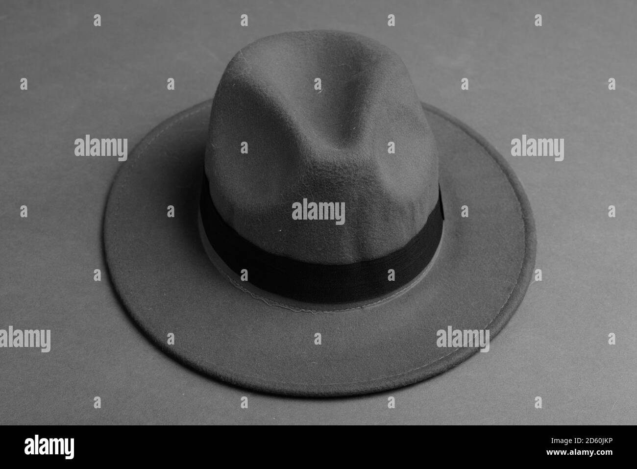 Fedora Hat Against Gray Background In Black And White Stock Photo