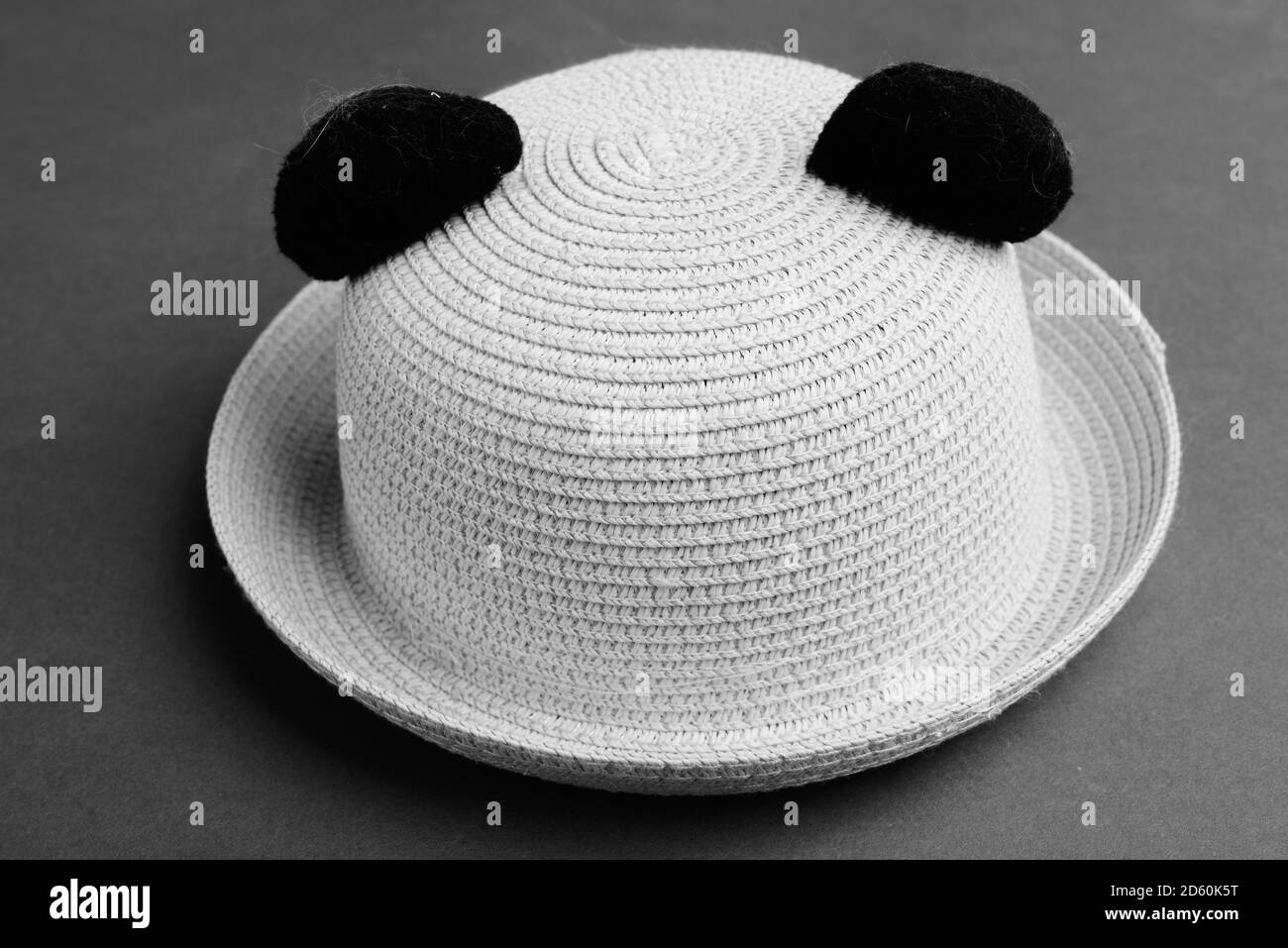 Sun Hat Against Gray Background In Black And White Stock Photo