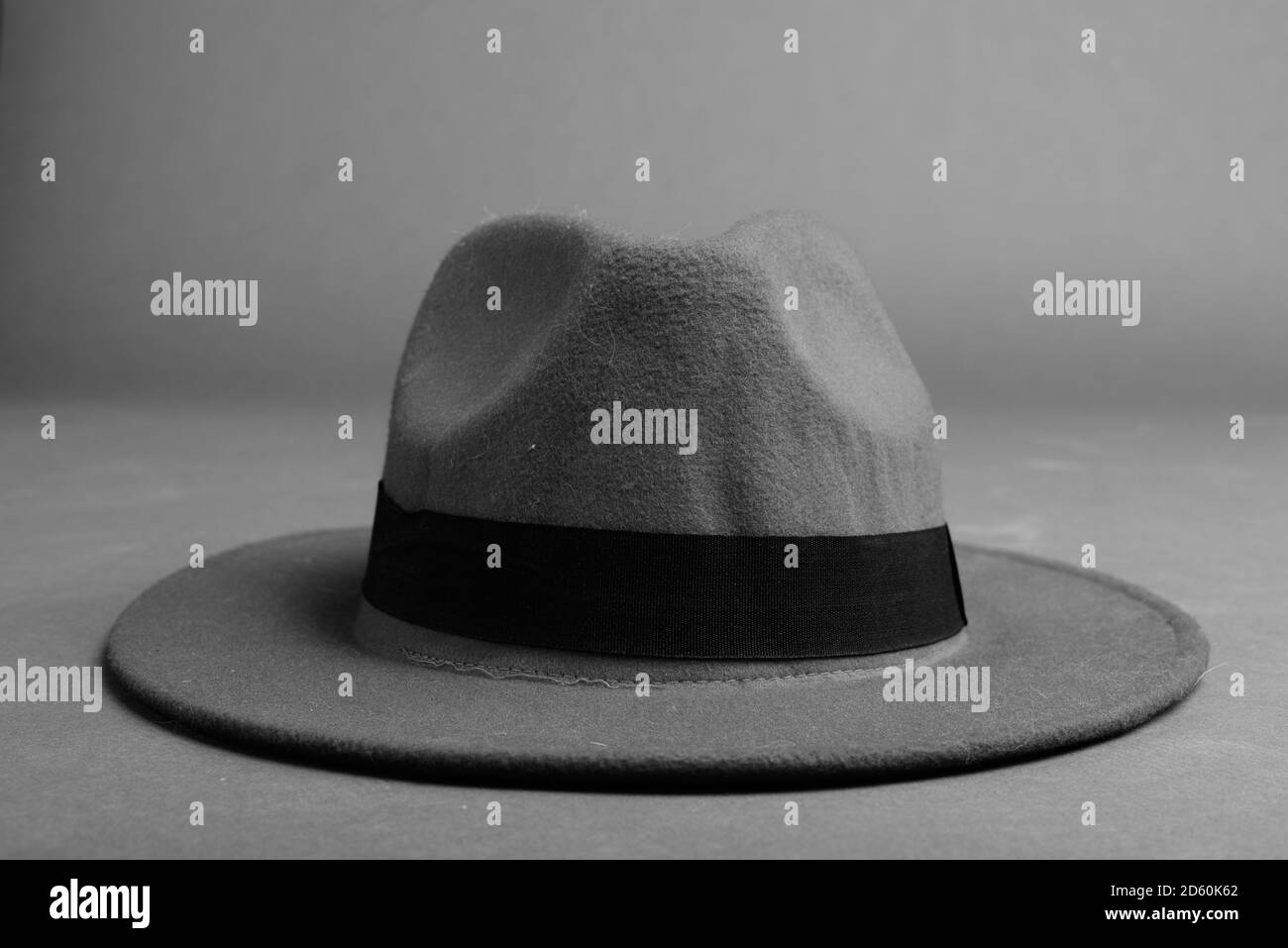 Fedora Hat Against Gray Background In Black And White Stock Photo