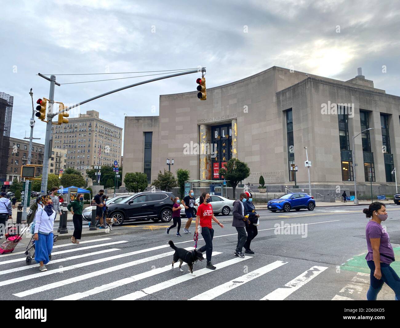 People cross the street at Eastern Parkway and Flatbush Avenue at the
