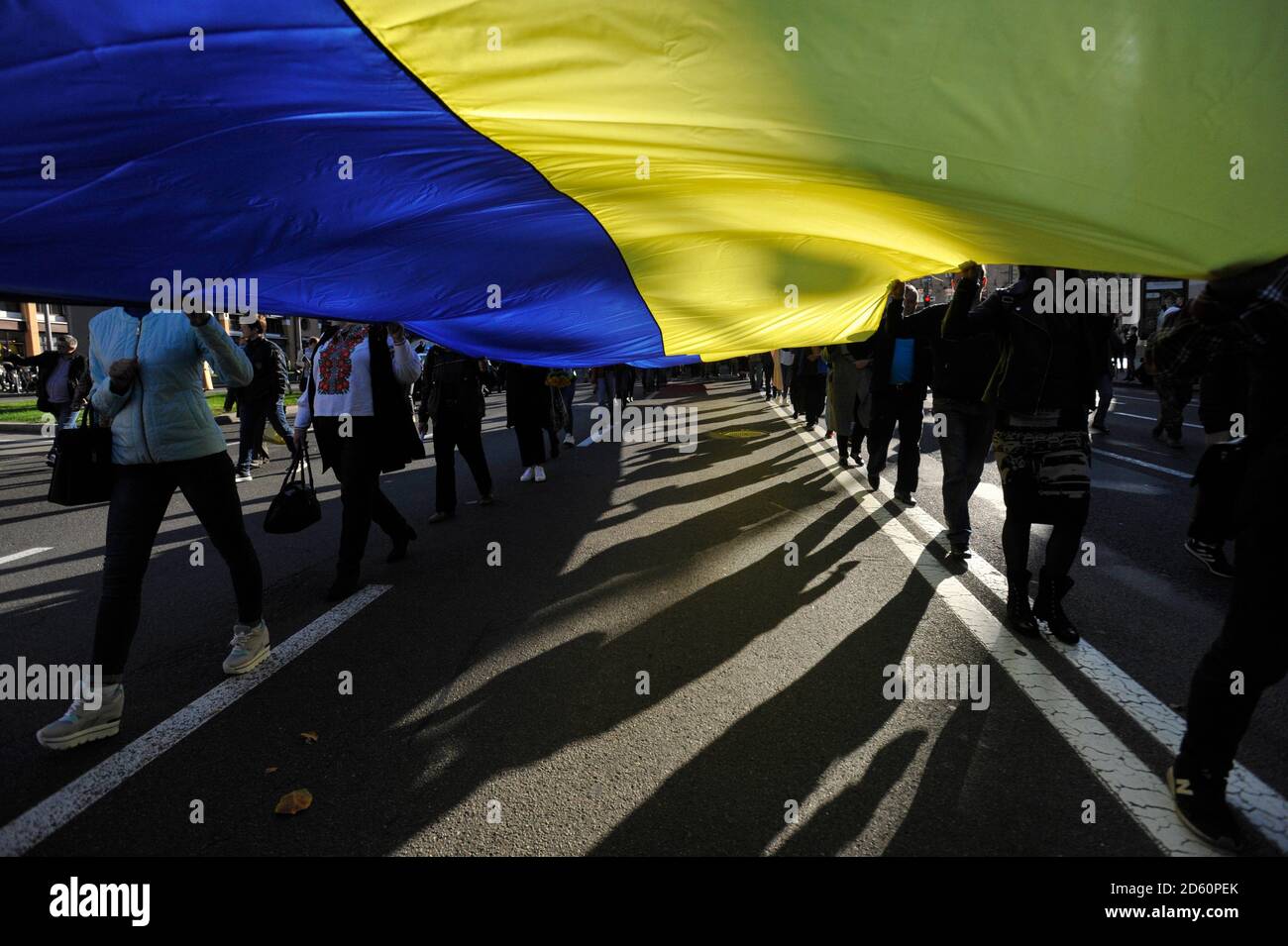 Kiev, Ukraine. 14th Oct, 2020. Activists marching with a huge Ukrainian ...