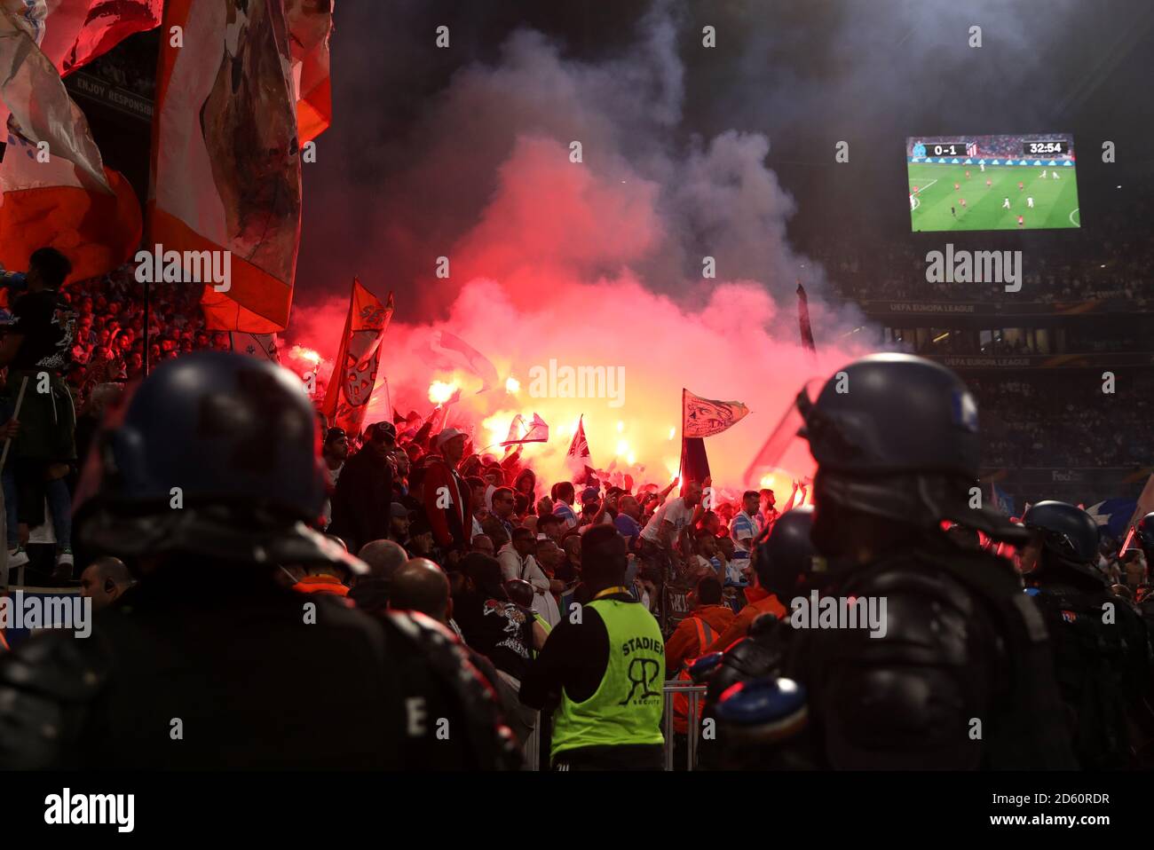 Fans lights flares in the stands as police look on Stock Photo Alamy