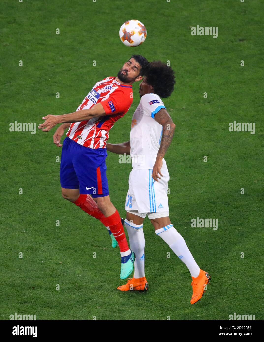 Atletico Madrid's Diego Costa (left) and Marseille's Luiz Gustavo battle for the ball Stock Photo