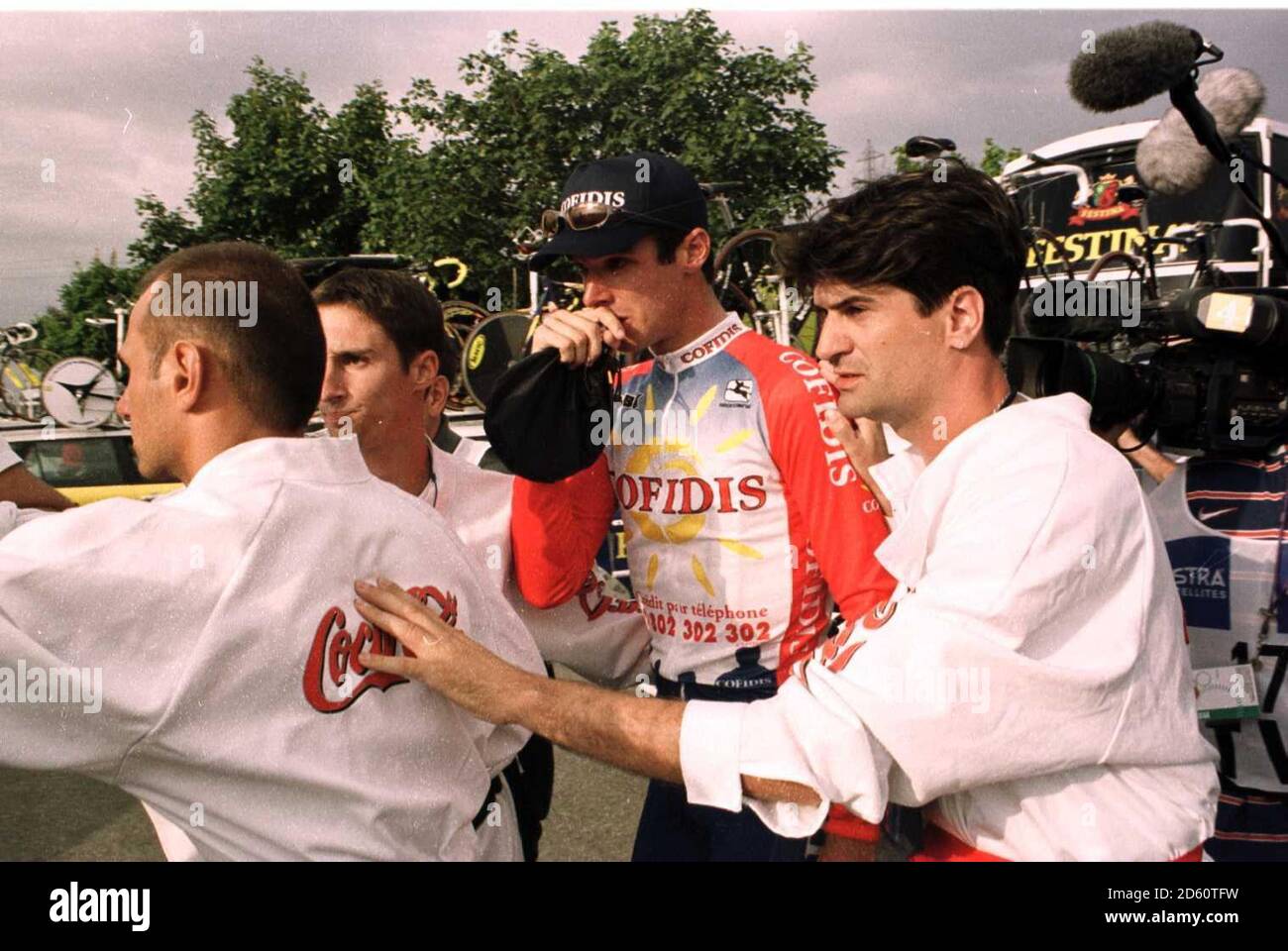 An emotional David Millar of Great Britain is surrounded by minders after sensationally winning the opening time trial to take the yellow jersey on his debut ride in the Tour  Stock Photo