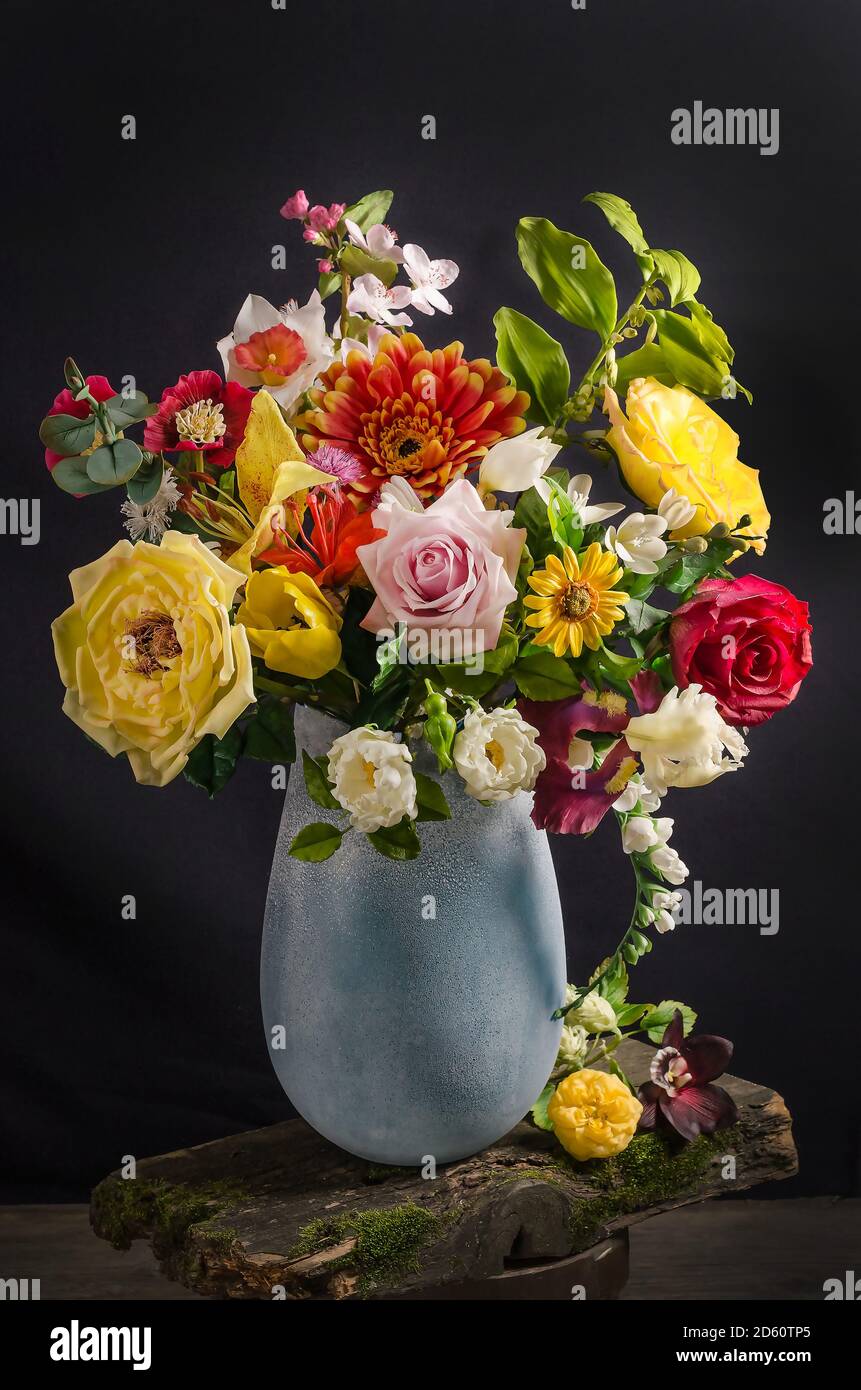 Elegant bouquet of flowers in a vase on a black background in dark ...