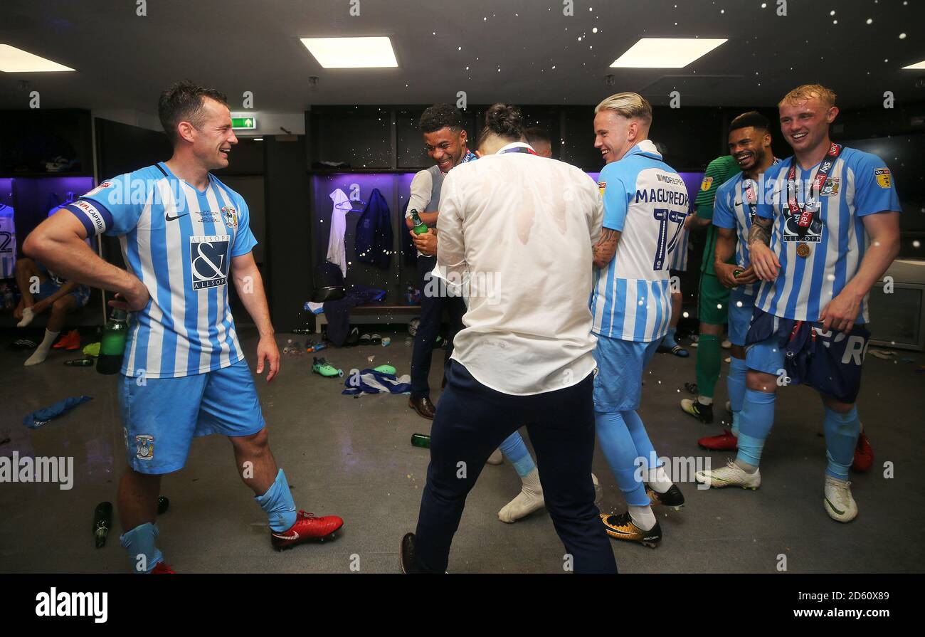 (left to right) Coventry City's Michael Doyle, Jordan Thompson, Jodi Jones, Jordan Maguire-Drew, Jordan Willis and Jack Grimmer celebrate in the dressing room after the game Stock Photo