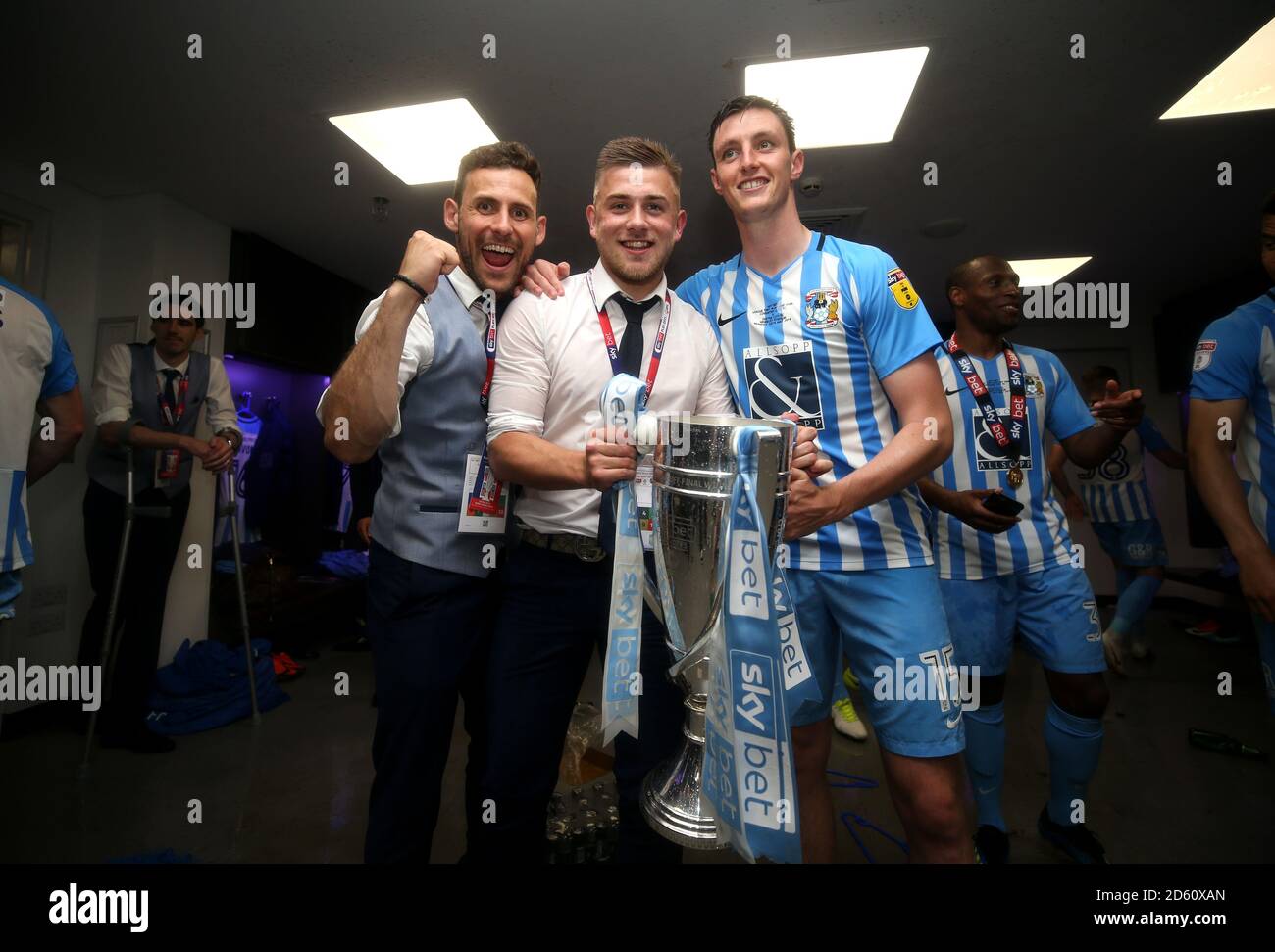 Coventry City's Josh Barrett (centre) and Dominic Hyam  celebrate in the dresing room after the game Stock Photo