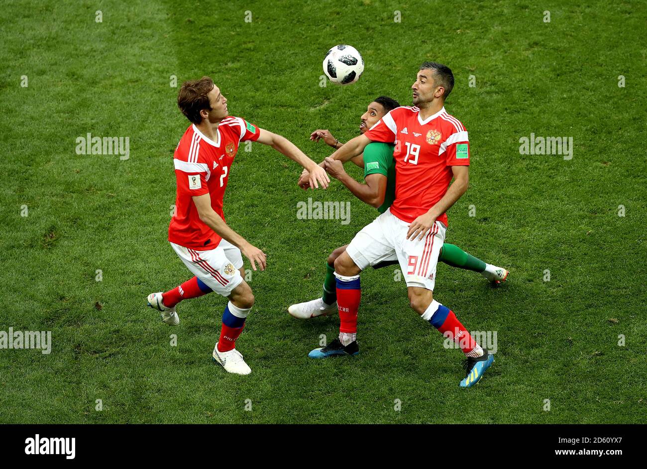 Saudi Arabia's Salem Al-Dawsari (centre) battles for the ball with Russia's Mario Fernandes (left) and Russia's Aleksandr Samedov  Stock Photo