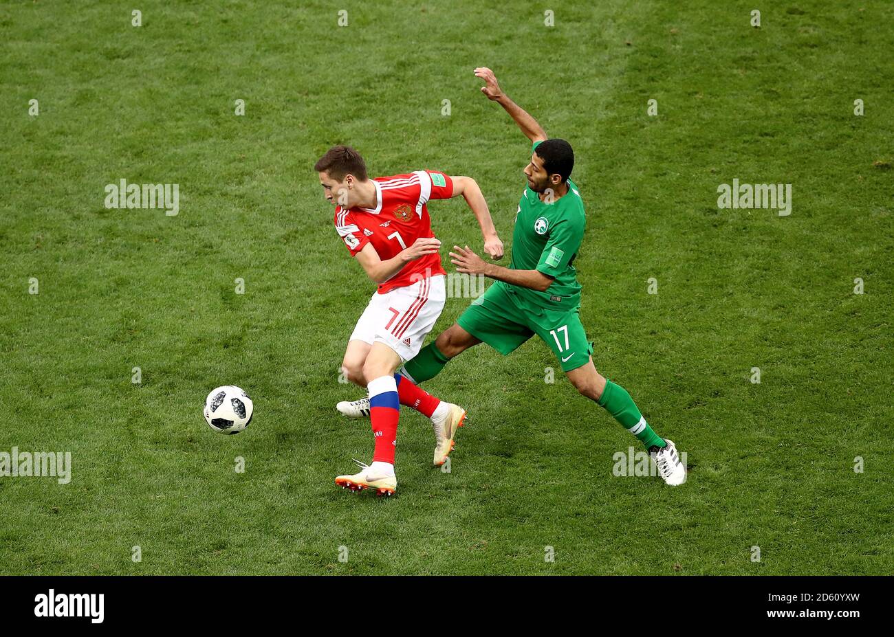 Russia's Daler Kuzyayev (left) and Saudi Arabia's Taisir Al-Jassim battle for the ball Stock Photo