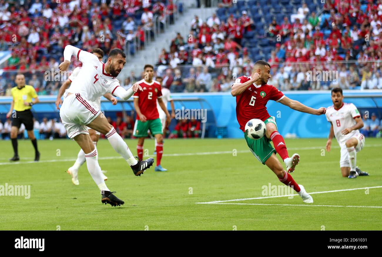 Iran's Rouzbeh Cheshmi (left) attempts a shot on goal Stock Photo