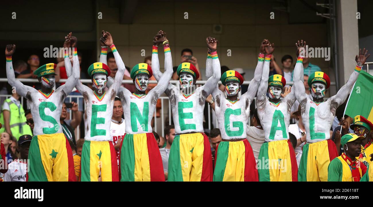 Senegal fans with the team name painted on their bodies during the game