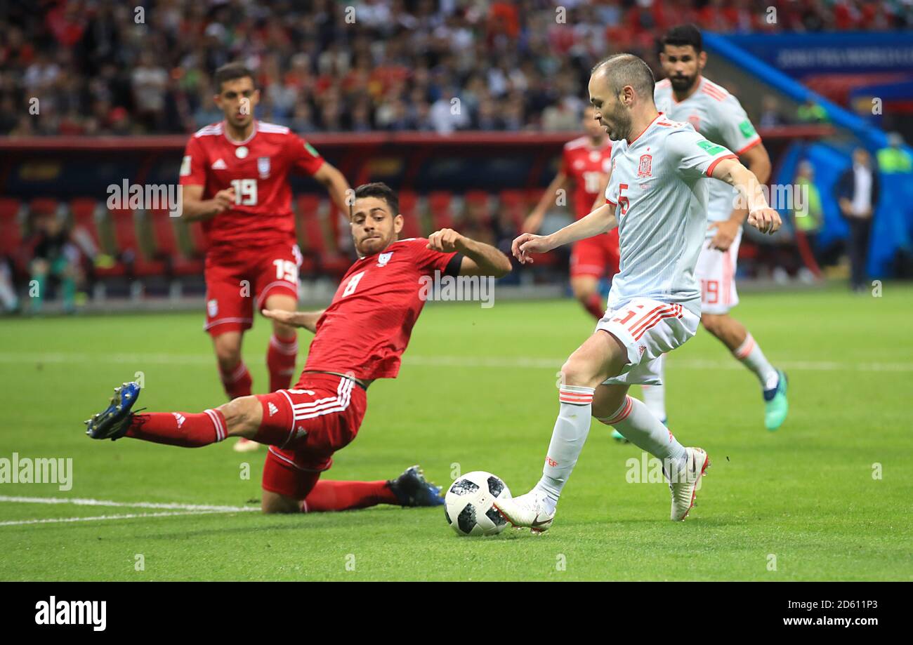 Iran's Milad Mohammadi (left) and Spain's Andres Iniesta battle for the ball Stock Photo