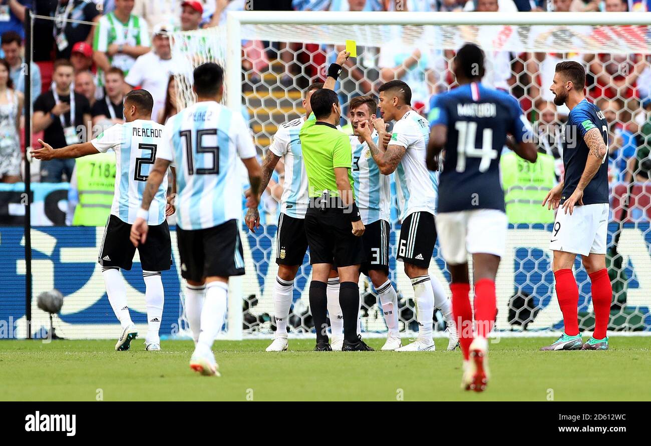 Argentina's Nicolas Tagliafico (3) is booked by match referee Alireza Faghani Stock Photo