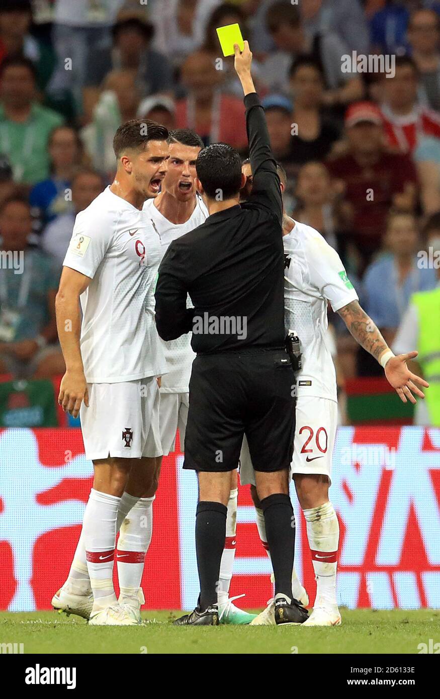 Portugal's Cristiano Ronaldo (second left) receives a yellow card from