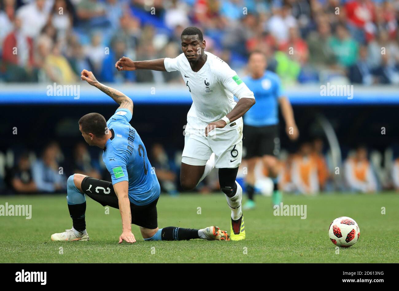 France's Paul Pogba (centre) goes to ground after a challenge Uruguay's Jose Gimenez Stock Photo