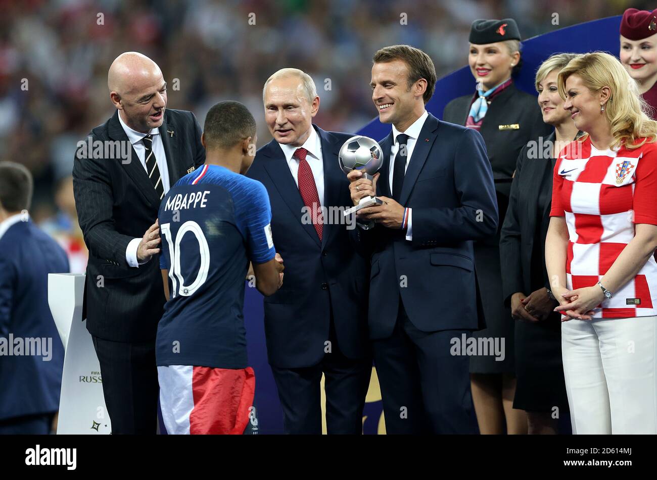 France's Kylian Mbappe receives the Best Young Player Award from FIFA President Gianni Infantino (left), Russian President Vladimir Putin (centre), French President Emmanuel Macron (rigth) after the FIFA World Cup 2018 final at the Luzhniki Stadium in Moscow, 15th July 2018 Stock Photo