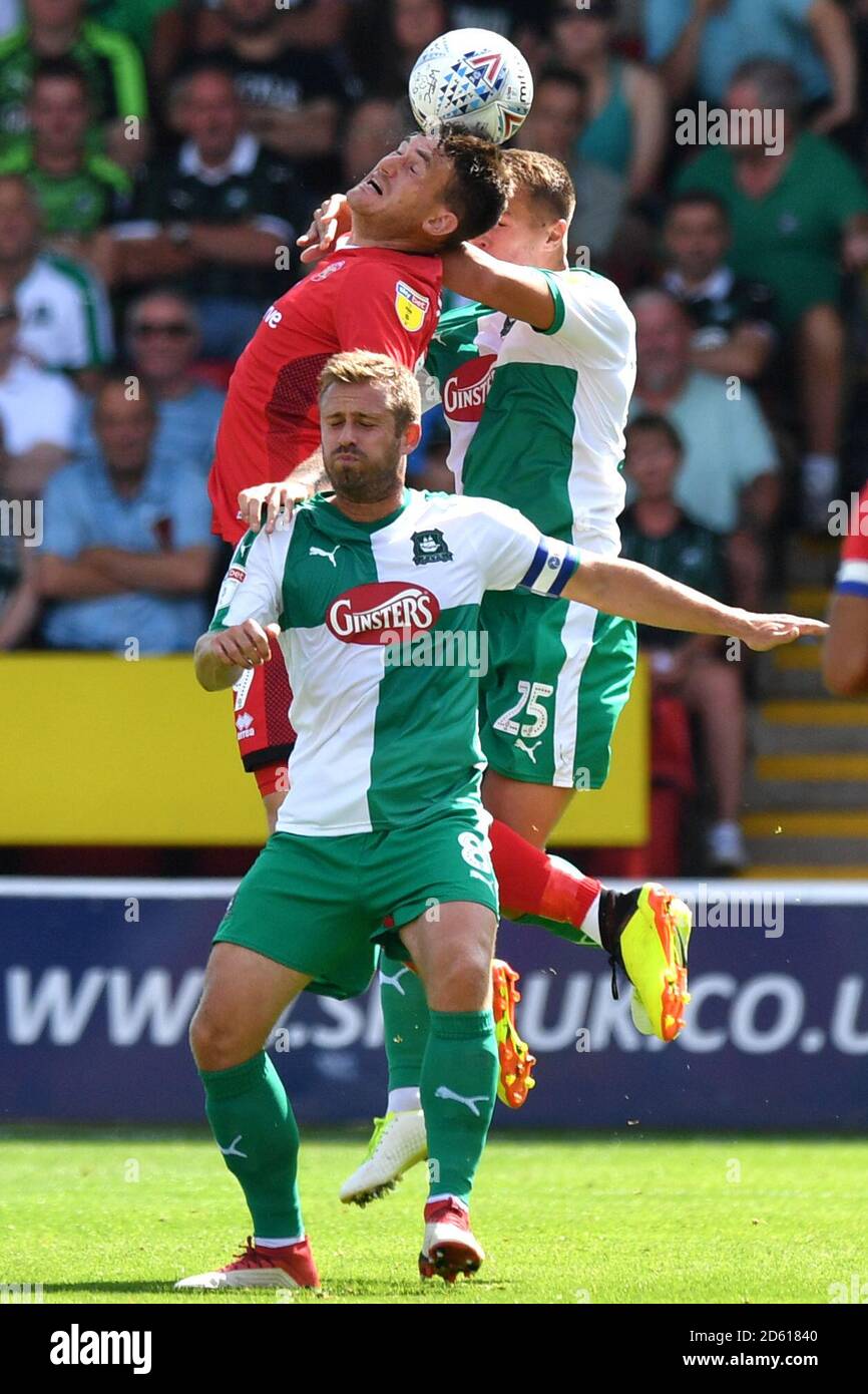 Walsall's Andy Cook and Plymouth Argyle's Scott Wootton compete for a header Stock Photo