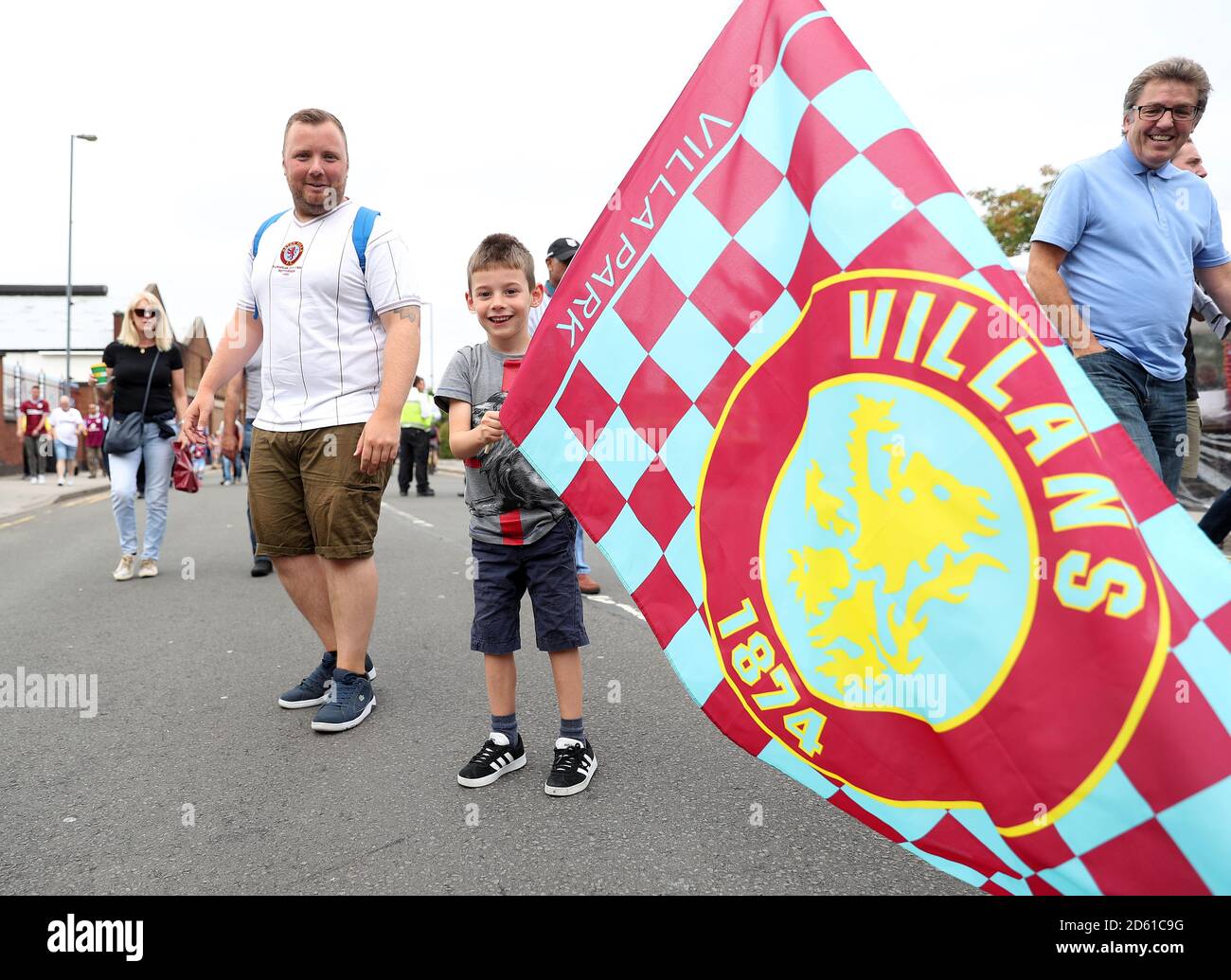 A young fan waves an Aston Villa flag outside the ground before the game Stock Photo