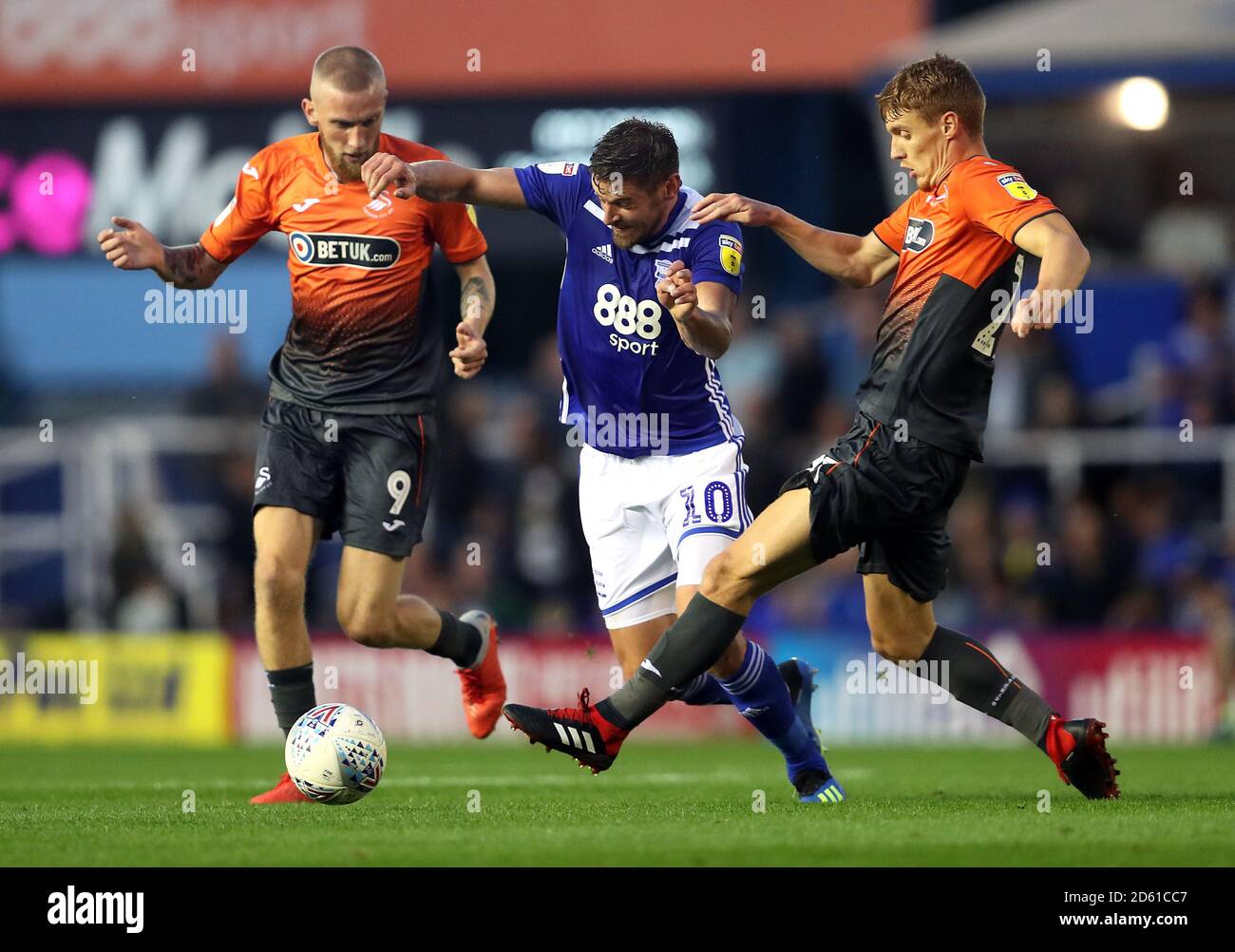 Birmingham City's Lukas Jutkiewicz (centre) battles for the ball with Swansea City's Oliver McBurnie (left) and Jay Fulton Stock Photo