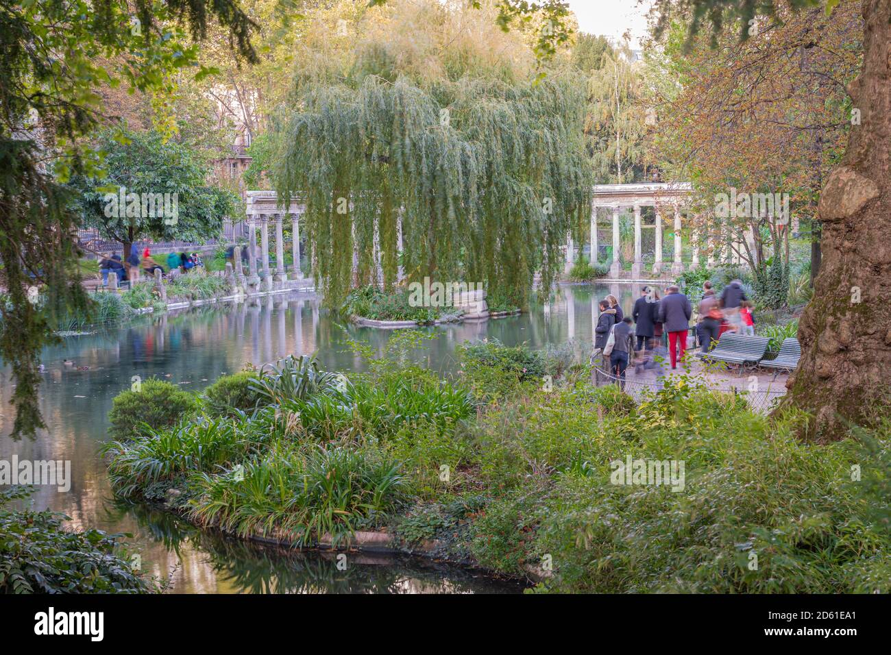 Paris, France - 10 11 2020: Golden hour in Parc Monceau in autumn. Oval basin bordered by a Corinthian colonnade Stock Photo