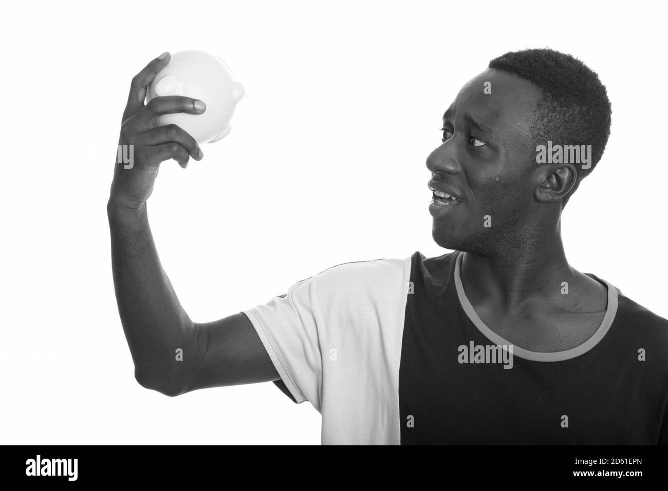 Shocked African man holding empty piggy bank Stock Photo - Alamy