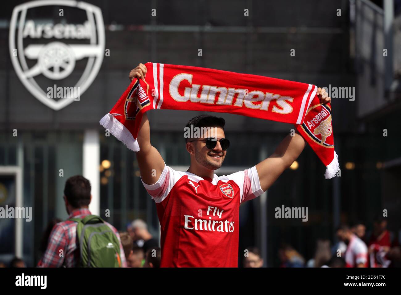 An Arsenal fan outside the Emirates Stadium holding up a Gunners scarf  Stock Photo - Alamy
