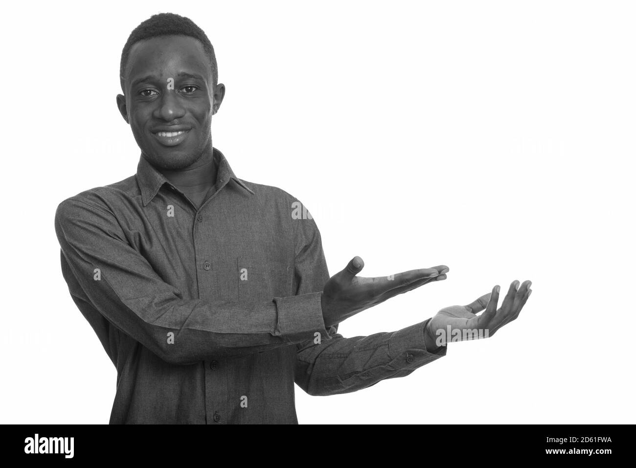 Young happy African man smiling and showing something Stock Photo - Alamy