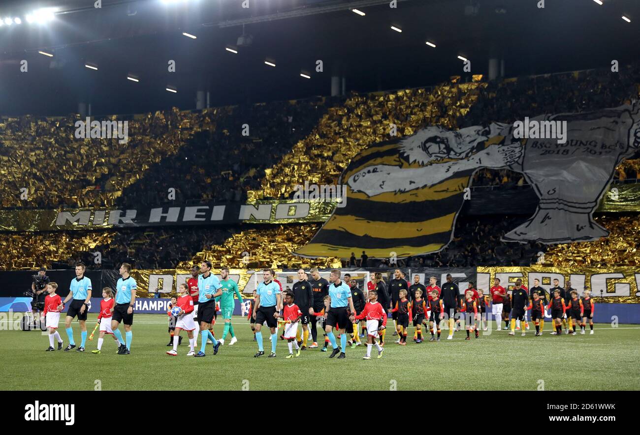 Manchester United and BSC Young Boys players walk out onto the pitch with the mascots and officials before the game Stock Photo