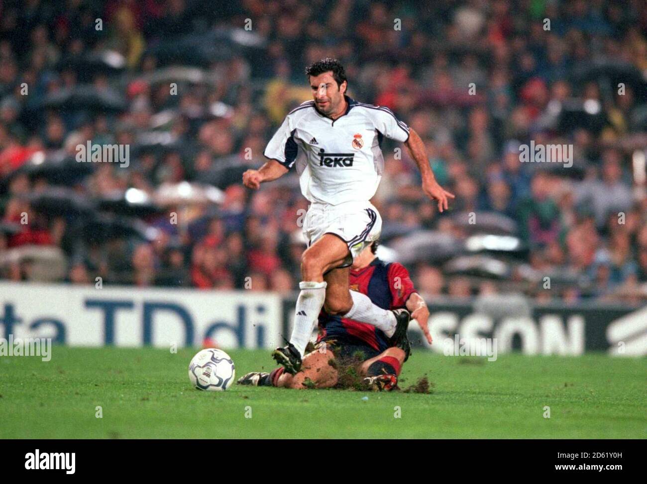 Barcelona's Carles Puyol (r) slides in on Real Madrid's Luis Figo (l) Stock Photo