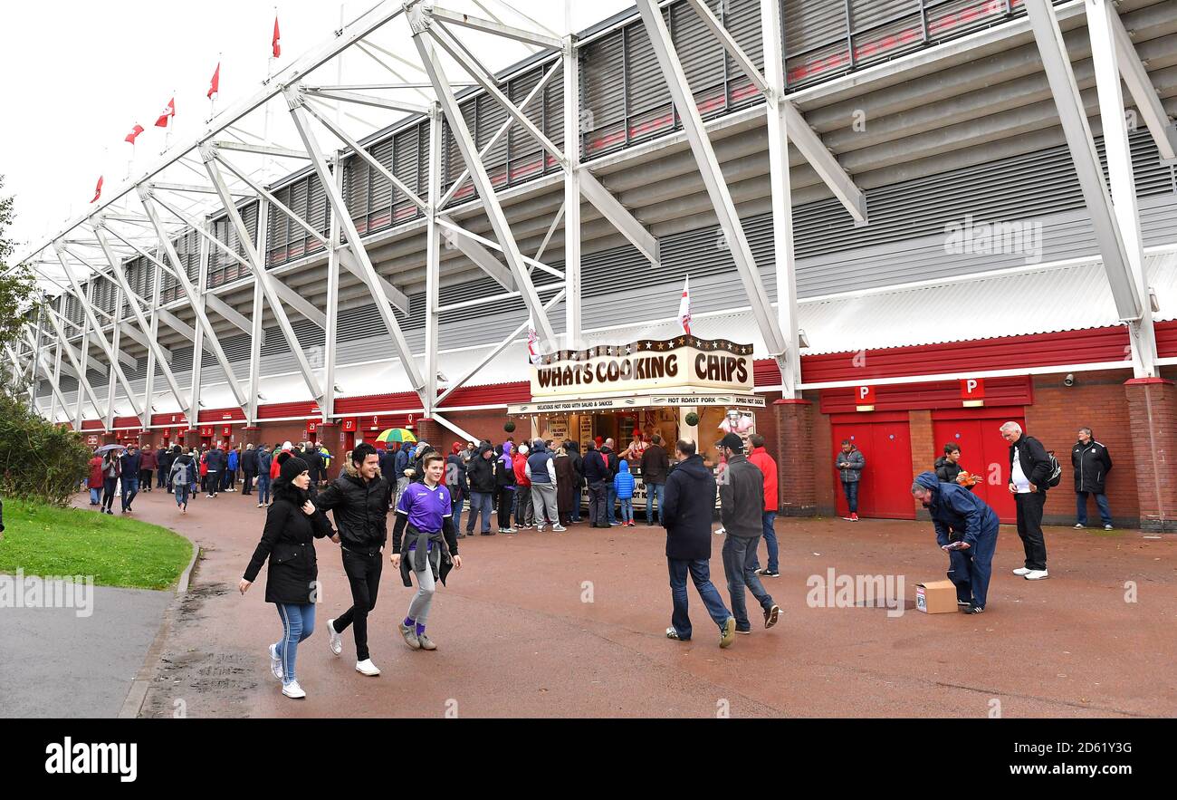Fans make their way to the stadium prior to the match Stock Photo