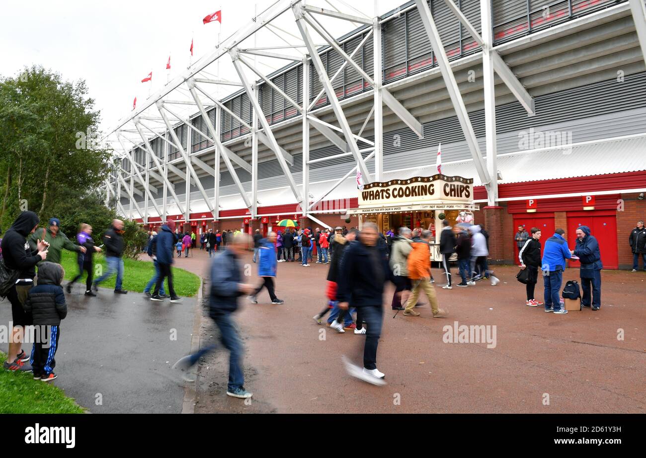 Fans make their way to the stadium prior to the match Stock Photo