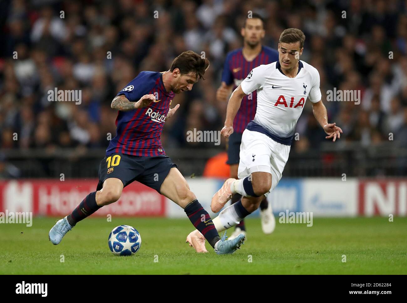 Barcelona's Lionel Messi (left) and Tottenham Hotspur's Harry Winks battle for the ball Stock Photo