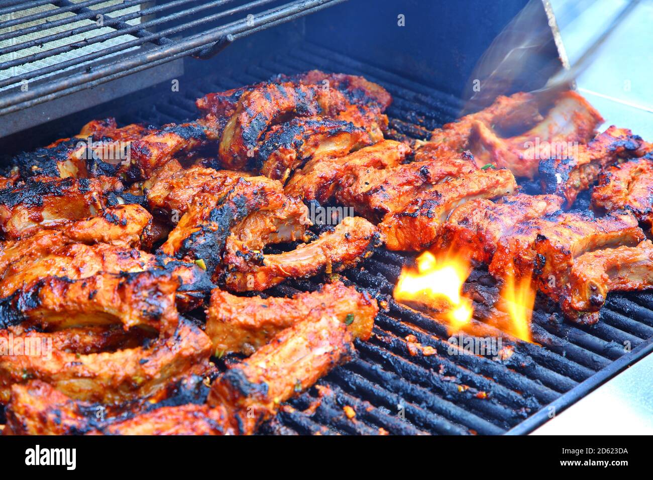 BBQ Pork Ribs Cooking on Grill Stock Photo